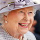 Queen of England smiles in a lavender getup